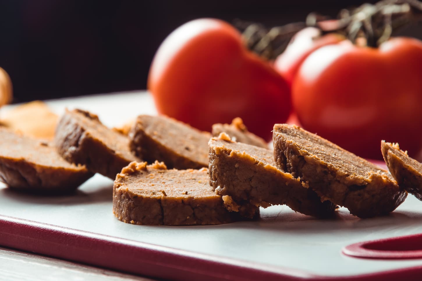 An image of sliced seitan loaf in a chopping board.