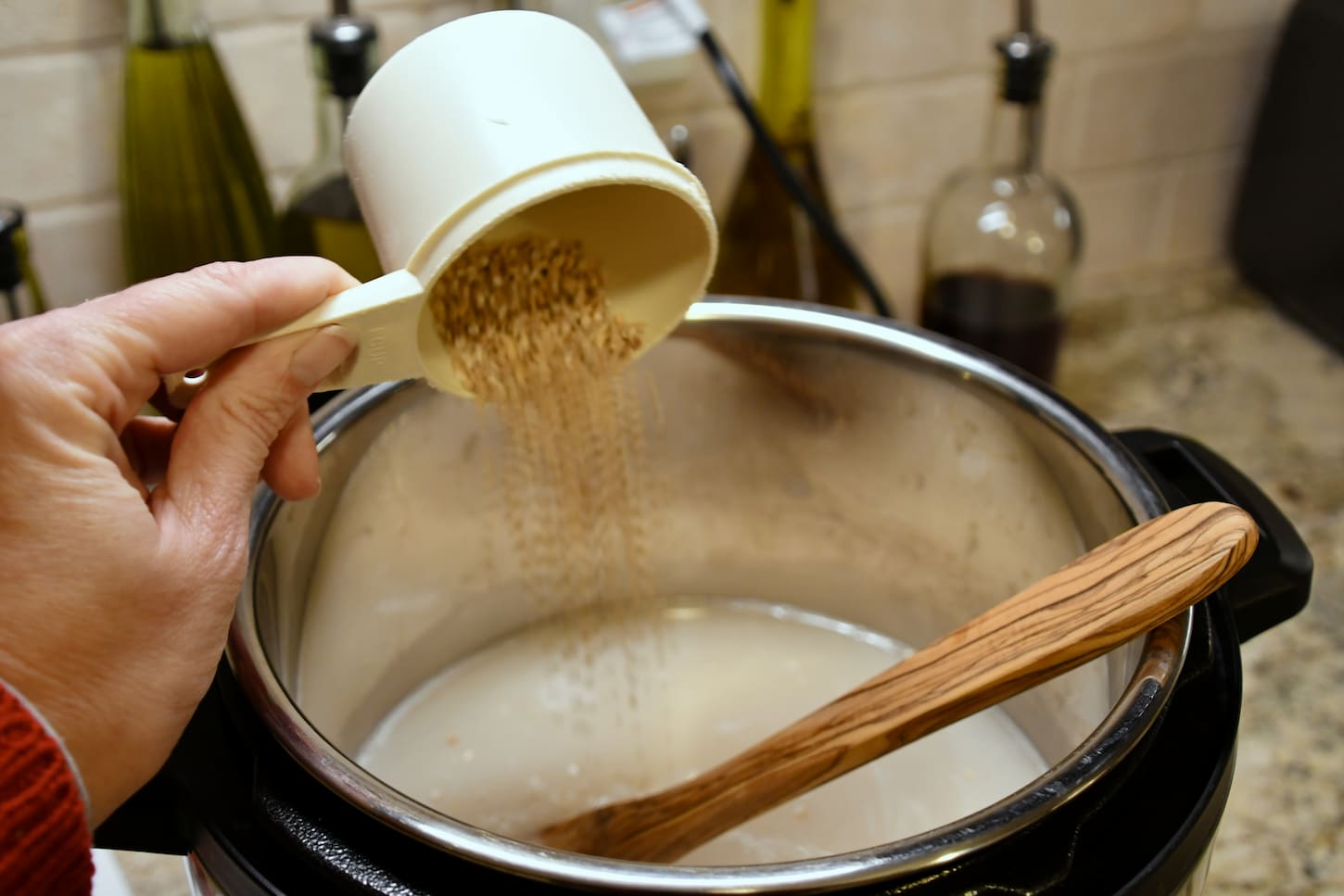 An image of steel-cut oats poured into an Instant Pot for creamy tasty porridge.