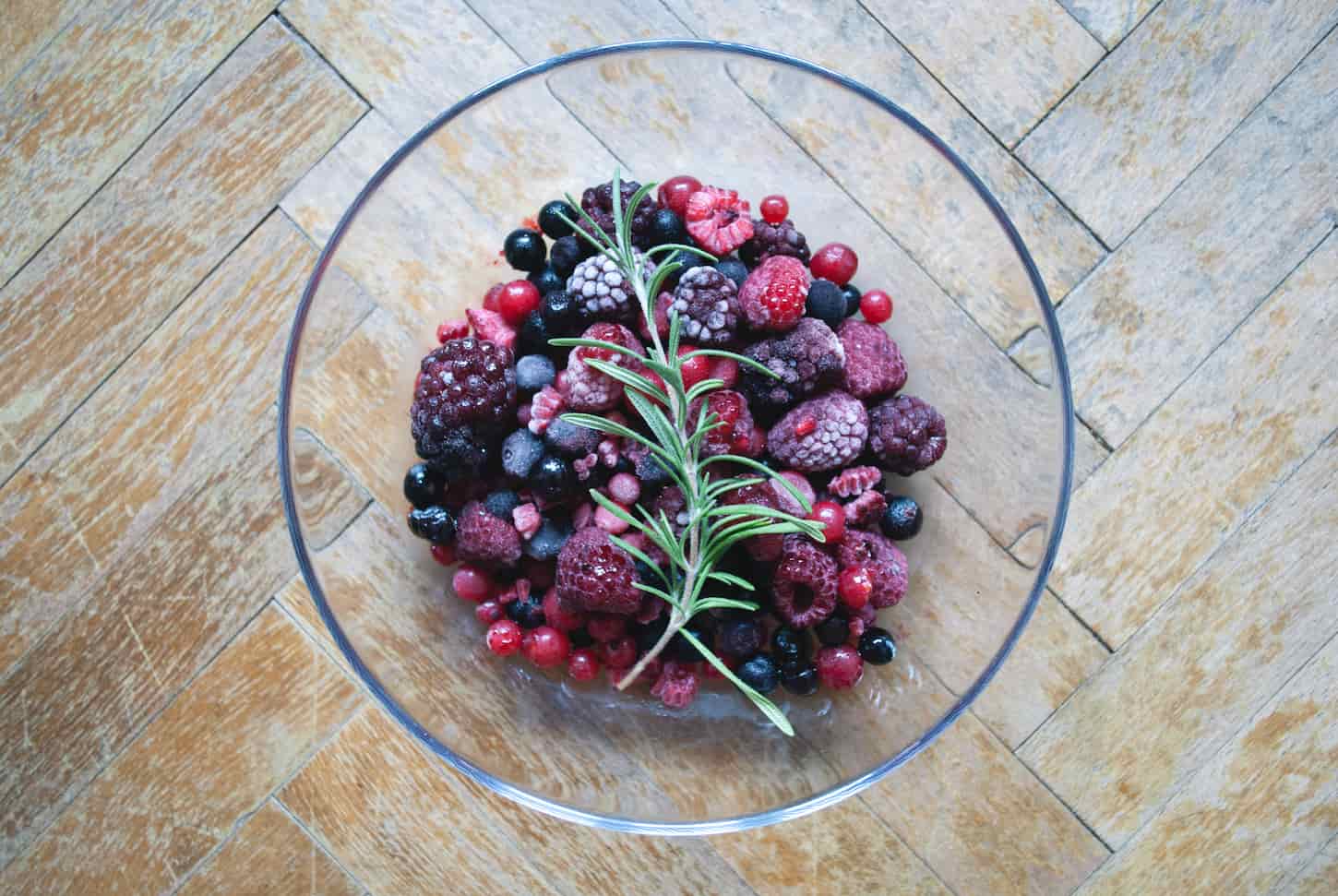 An image of a Glass bowl of frozen berries.
