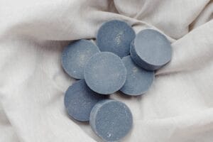 An image of Handmade solid shampoo and conditioner bars on a paper background.